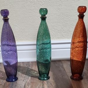 Colored bottles with stoppers.  Orange, green and purple.  EUC